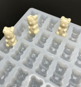 Close-up of 2.3mL gummy bear mold with 230 cavities and finished gummies